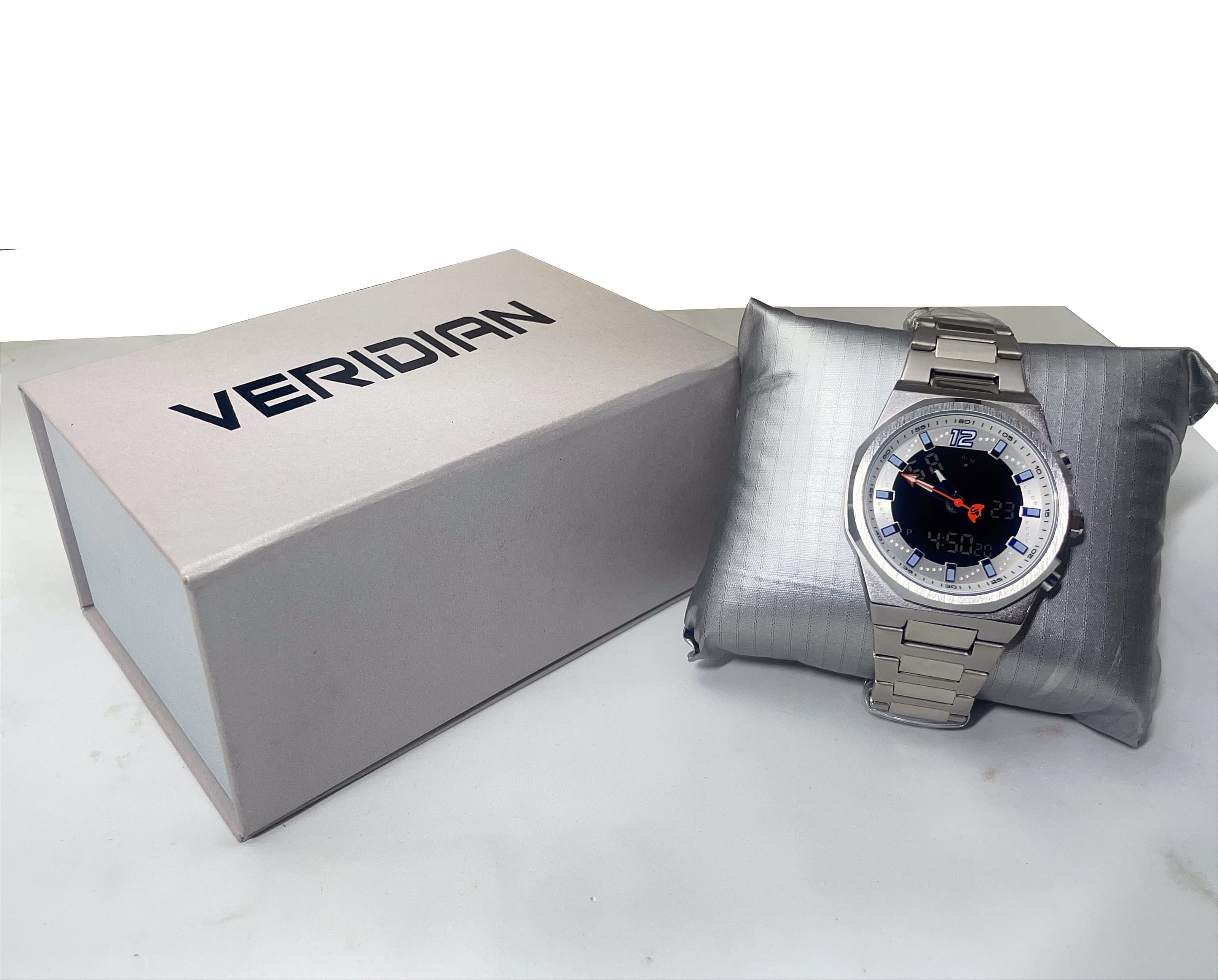 Silver watch with black face on a gray cushion next to a Veridian branded box on a white background